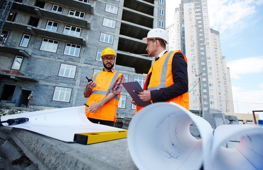 Construction workers looking over plans on a job site