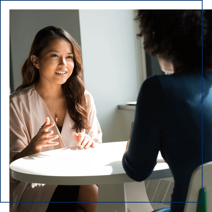 Two women sitting and talking
