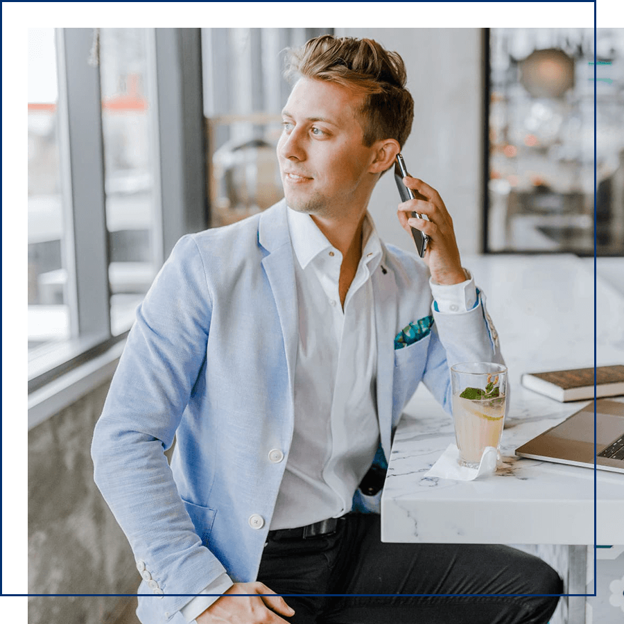 Man sitting in a well lit room on the phone